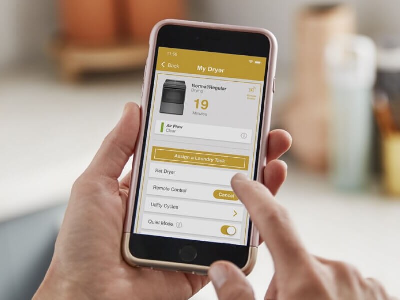 Person adjusting dryer settings on the Whirlpool® App Person adjusting dryer settings on the Whirlpool® App