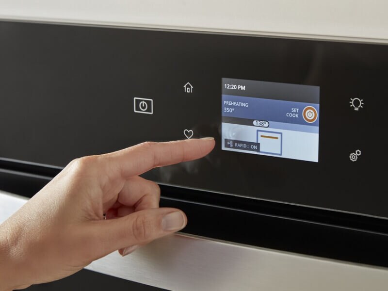 Person selecting settings on an appliance touchscreen Person selecting settings on an appliance touchscreen
