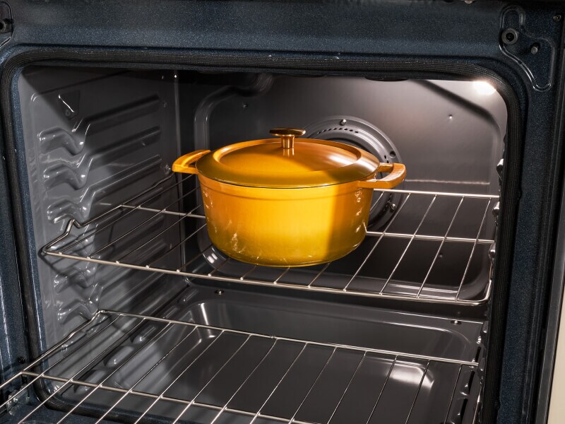 A Dutch Oven pot sitting in an open oven A Dutch Oven pot sitting in an open oven