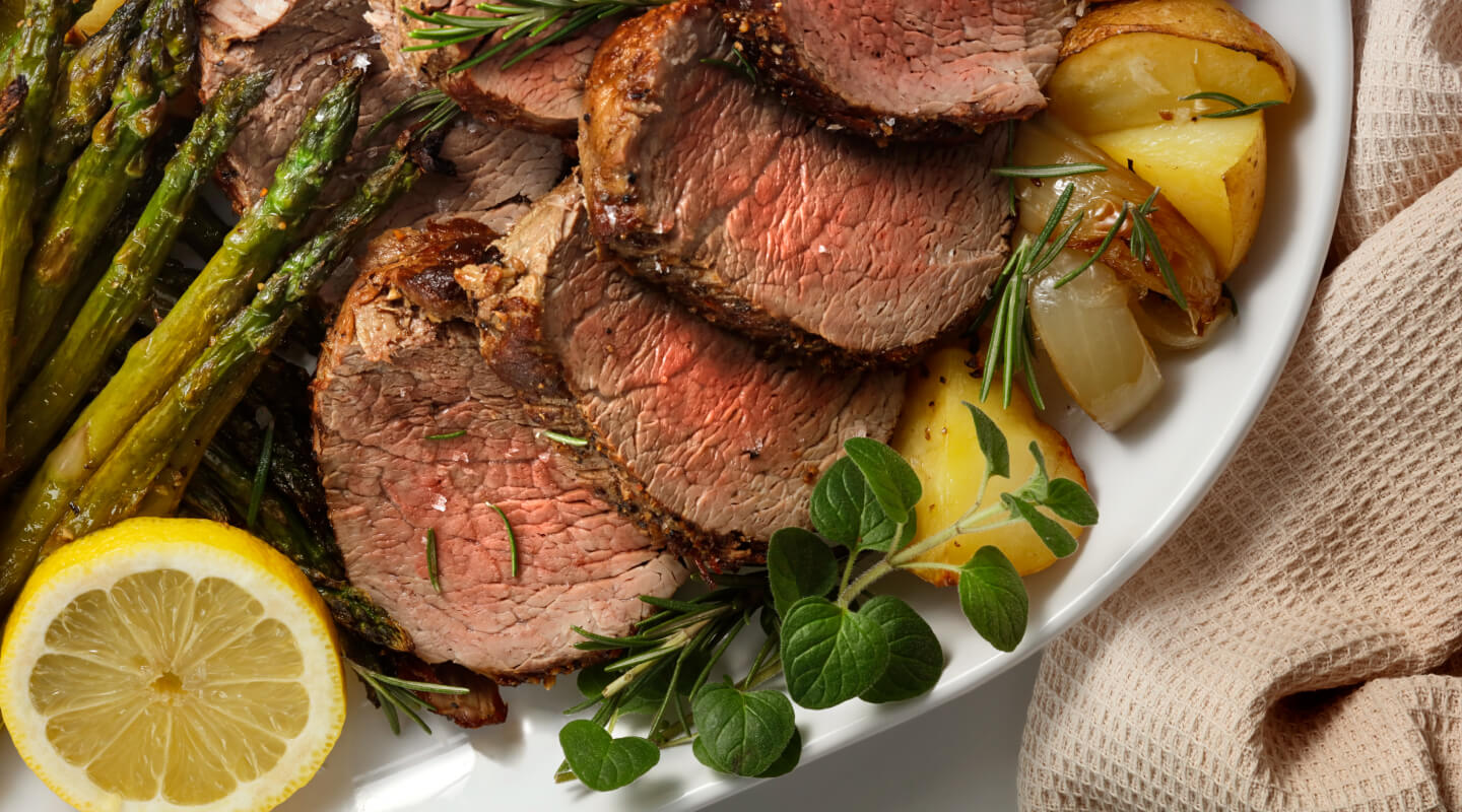 Sliced steak with potatoes and veggies on a plate Sliced steak with potatoes and veggies on a plate