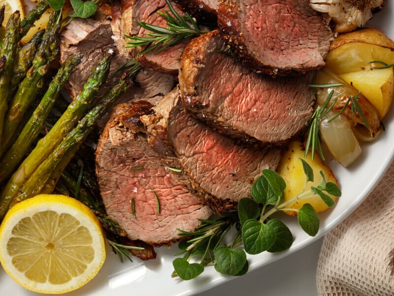 Sliced steak with potatoes and veggies on a plate Sliced steak with potatoes and veggies on a plate