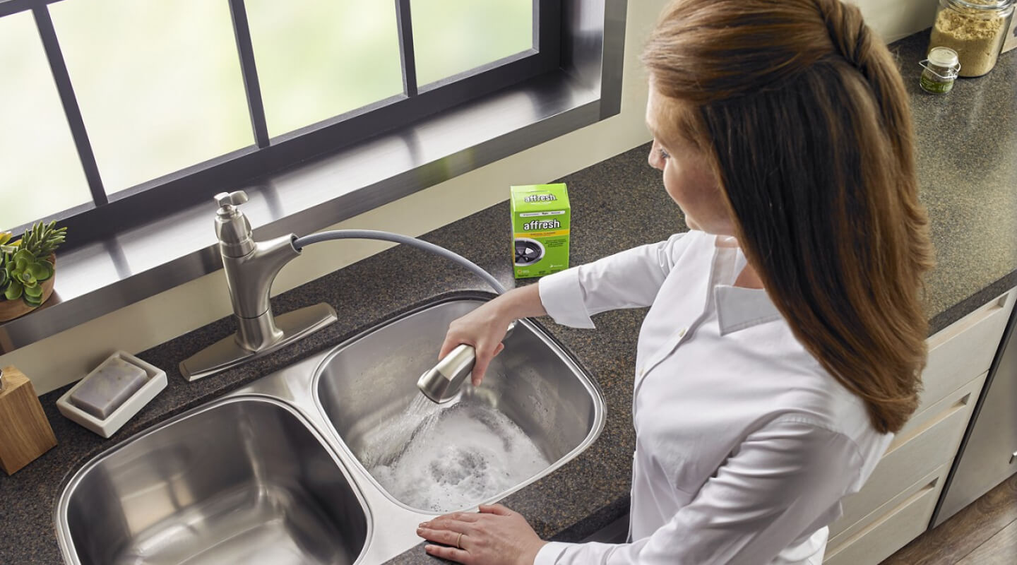 Person cleaning their garbage disposal Person cleaning their garbage disposal