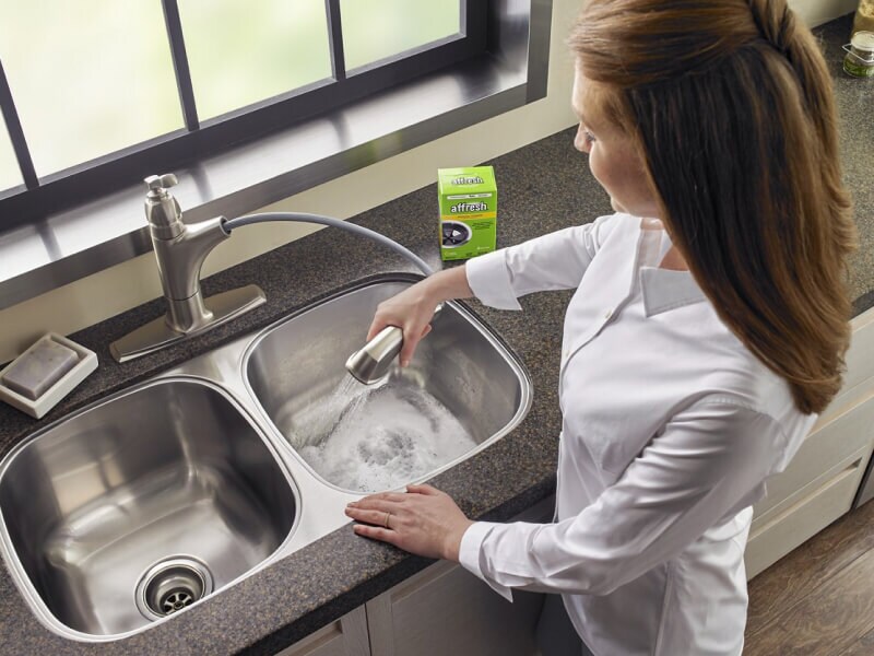 Person cleaning their garbage disposal Person cleaning their garbage disposal