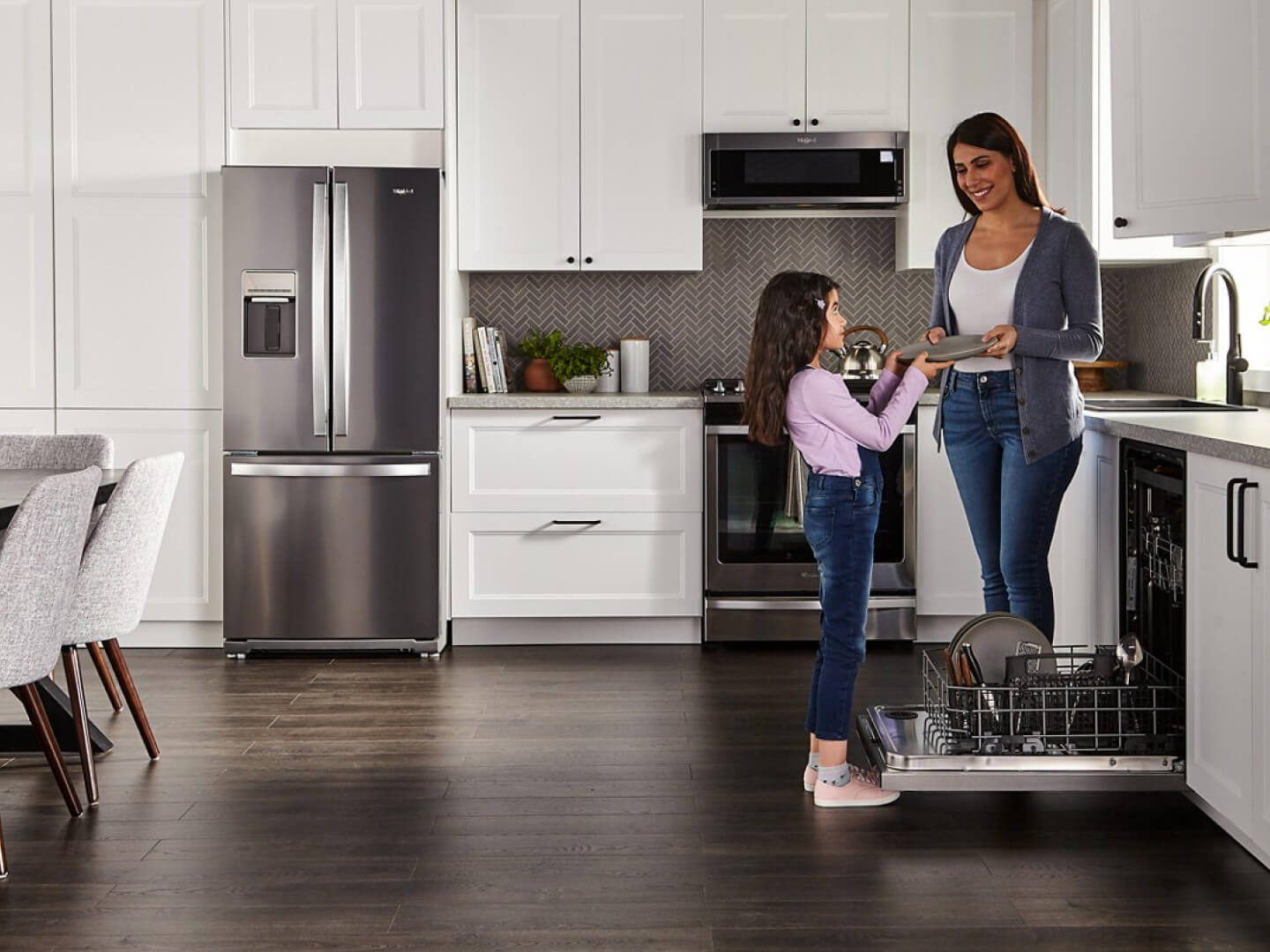 Parent and child unloading the dishwasher