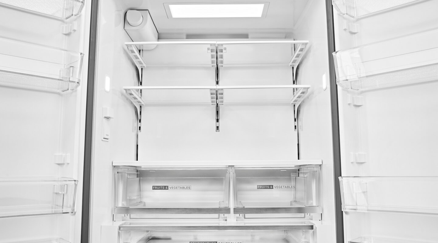 The empty inside of a Whirlpool® French Door Refrigerator
