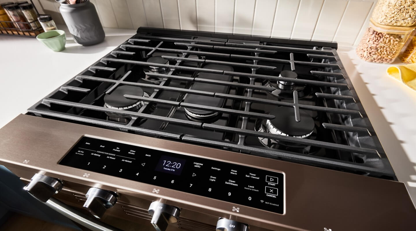 Overhead view of the grates and burners on a black stainless gas slide-in rangen