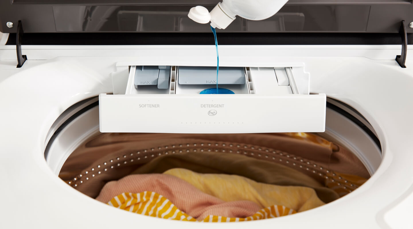 Detergent pouring into a detergent dispenser on a Whirlpool® Washer Detergent pouring into a detergent dispenser on a Whirlpool® Washer