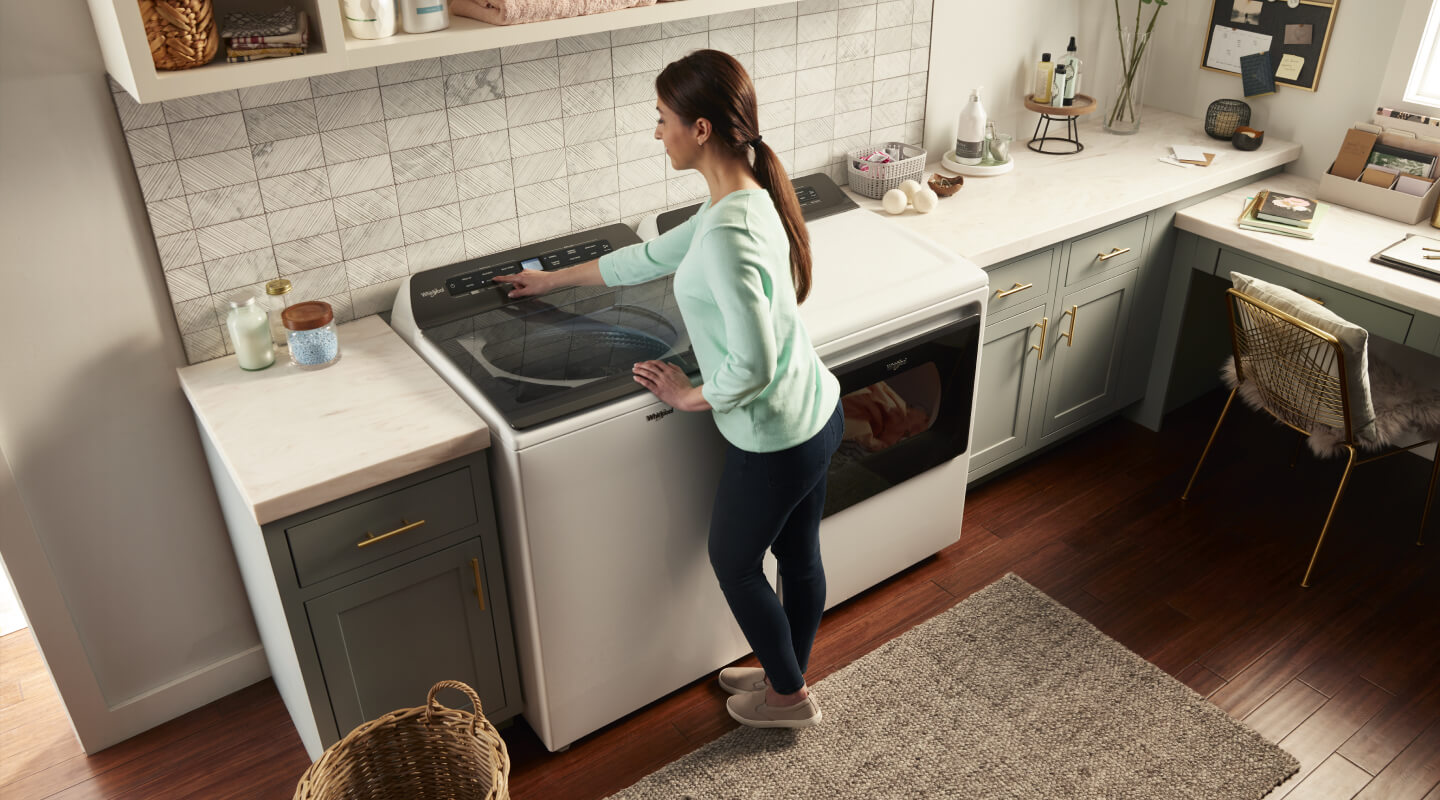 Person making a selection on a washing machine control panel Person making a selection on a washing machine control panel
