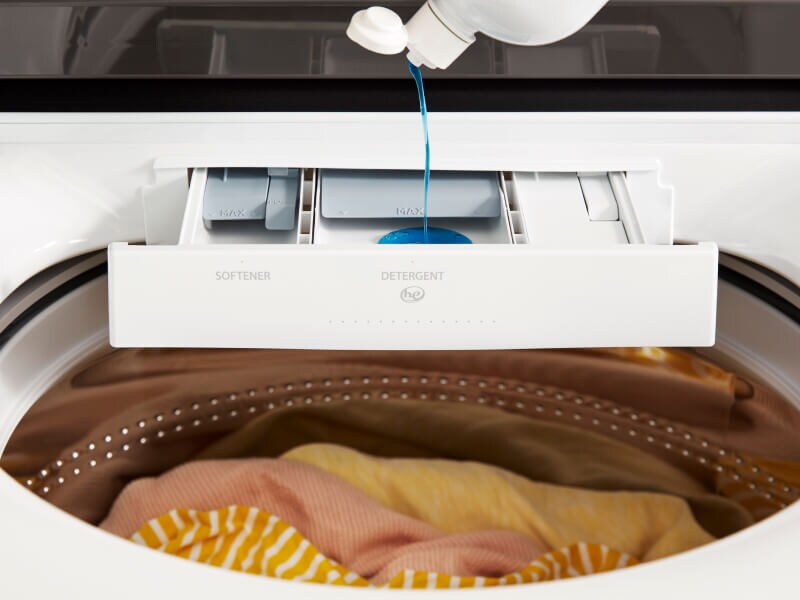 Detergent pouring into a detergent dispenser on a Whirlpool® Washer Detergent pouring into a detergent dispenser on a Whirlpool® Washer