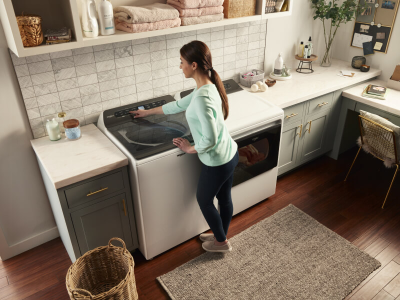 Person making a selection on a washing machine control panel Person making a selection on a washing machine control panel