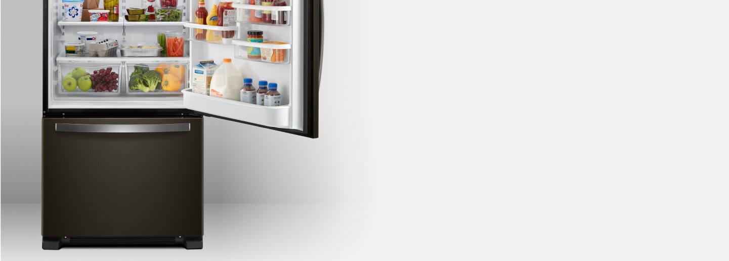An open Whirlpool® bottom freezer refrigerator