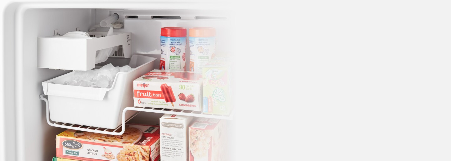 A closeup of an open Whirlpool® top freezer refrigerator