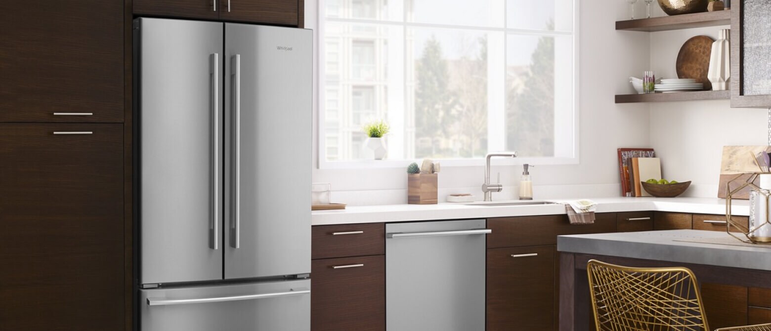 A side-by-side refrigerator in a kitchen with a flush dishwasher A side-by-side refrigerator in a kitchen with a flush dishwasher
