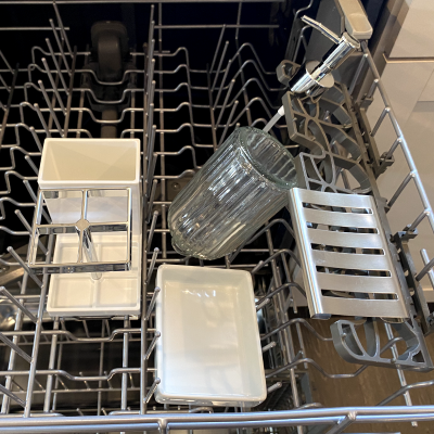 Bathroom accessories on the top rack of a dishwasher