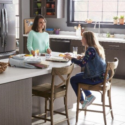 Two people talking at a kitchen island