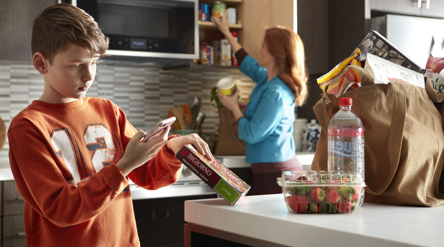 Person scanning a food barcode with a phone Person scanning a food barcode with a phone