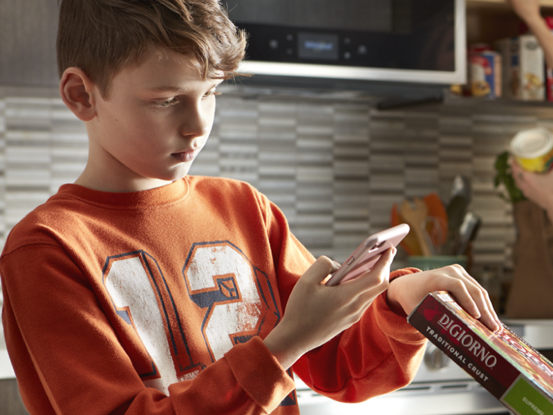 Person scanning a food barcode with a phone Person scanning a food barcode with a phone