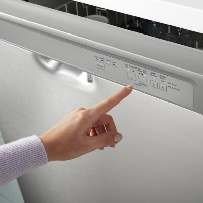 A hand selecting an option on a Whirlpool® Front Control Dishwasher