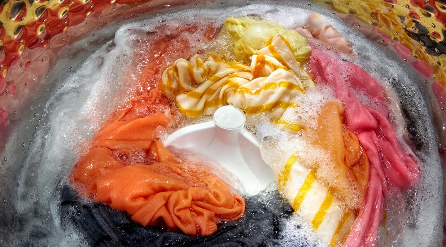 Soapy clothes washing in a washing machine Soapy clothes washing in a washing machine