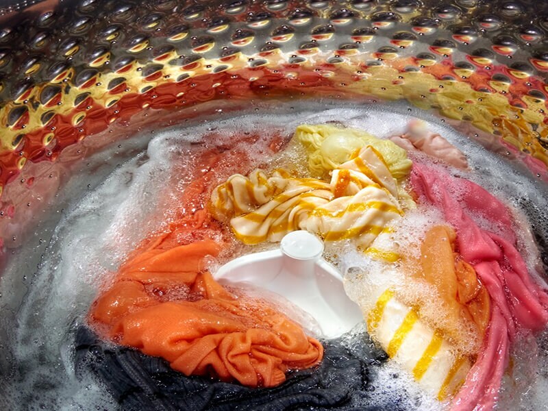Soapy clothes washing in a washing machine Soapy clothes washing in a washing machine