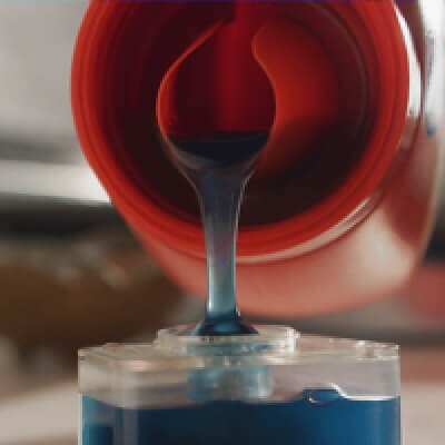 Close up of laundry detergent being poured into a cup