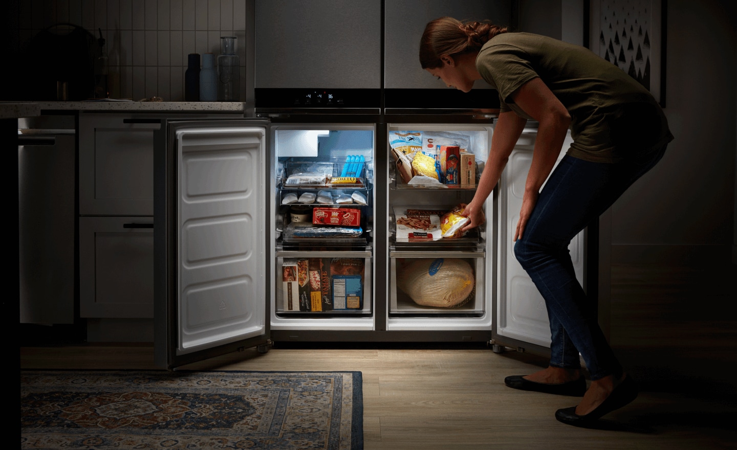 Person putting items in a freezer