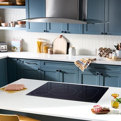Electric cooktop built into white kitchen island countertop