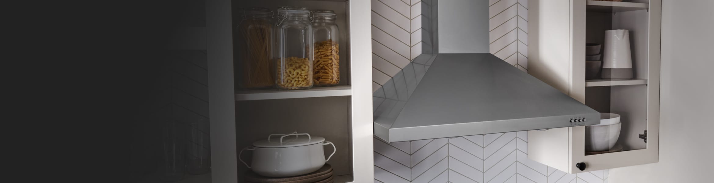 A canopy hood installed between cabinets.