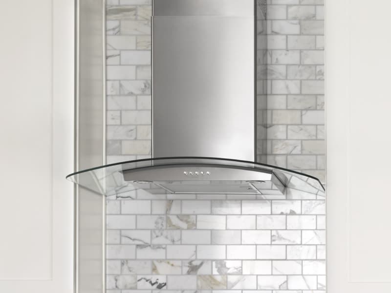 Glass-edged wall-mounted canopy hood between cabinets Glass-edged wall-mounted canopy hood between cabinets