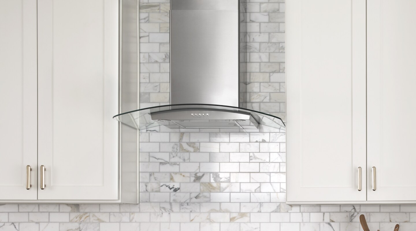 Glass-edged wall-mounted canopy hood between cabinets Glass-edged wall-mounted canopy hood between cabinets
