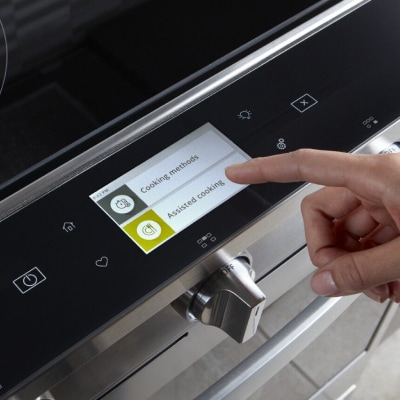 Person selecting a cook setting on a Whirlpool® smart oven