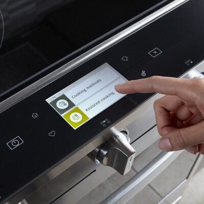Person selecting a cook setting on a Whirlpool® smart oven