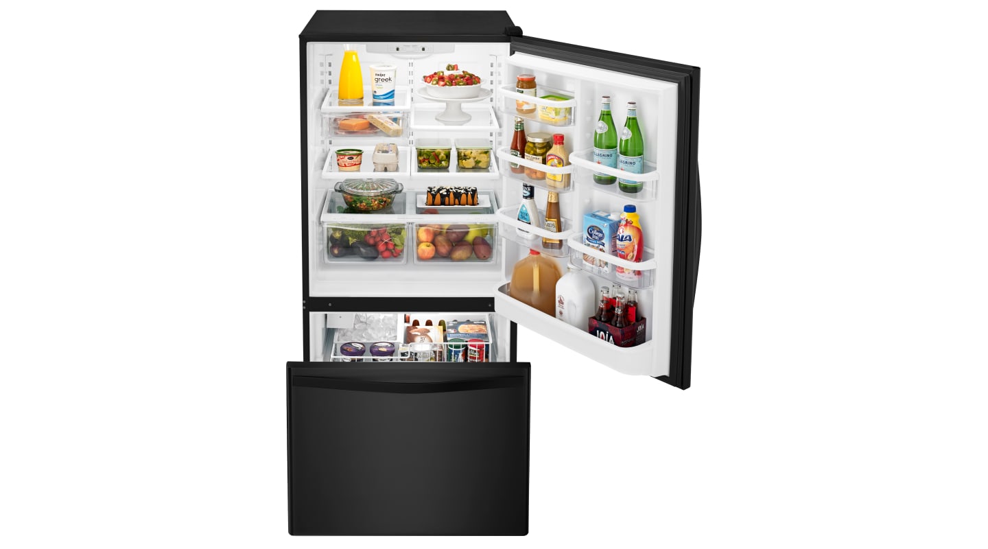 Open bottom-freezer refrigerator with food inside Open bottom-freezer refrigerator with food inside