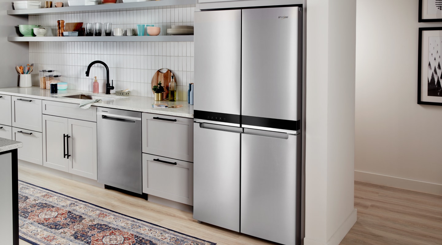 Stainless steel four-door refrigerator set in white cabinetry Stainless steel four-door refrigerator set in white cabinetry
