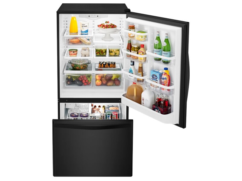Open bottom-freezer refrigerator with food inside Open bottom-freezer refrigerator with food inside