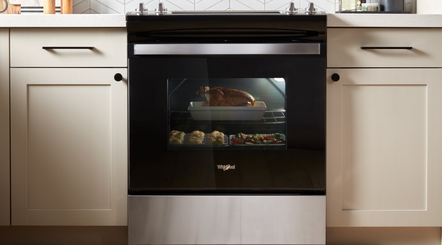 Turkey, rolls and vegetables in an oven Turkey, rolls and vegetables in an oven