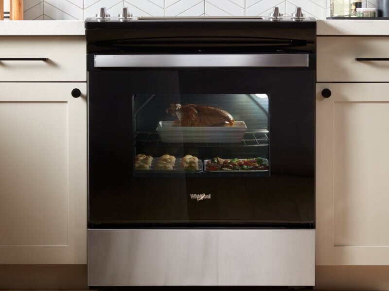 Turkey, rolls and vegetables in an oven Turkey, rolls and vegetables in an oven