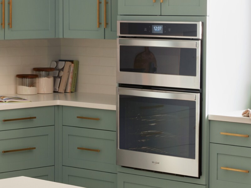 A double wall oven in a kitchen with green cabinetry A double wall oven in a kitchen with green cabinetry