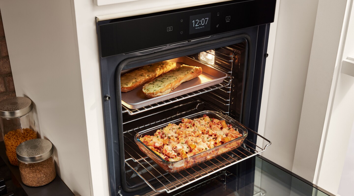 Various dishes cooking in a single wall oven Various dishes cooking in a single wall oven