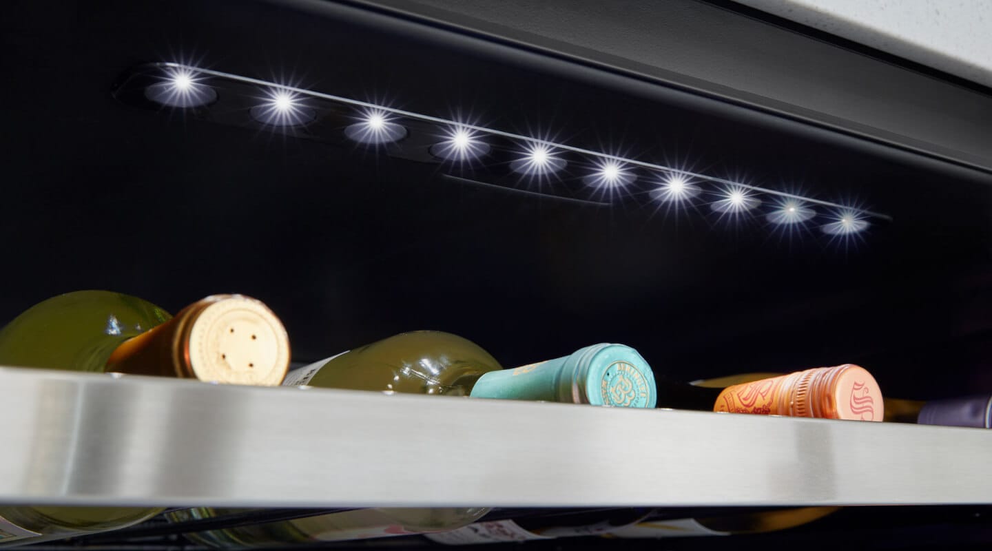 Up close image of wine bottles in an undercounter fridge Up close image of wine bottles in an undercounter fridge