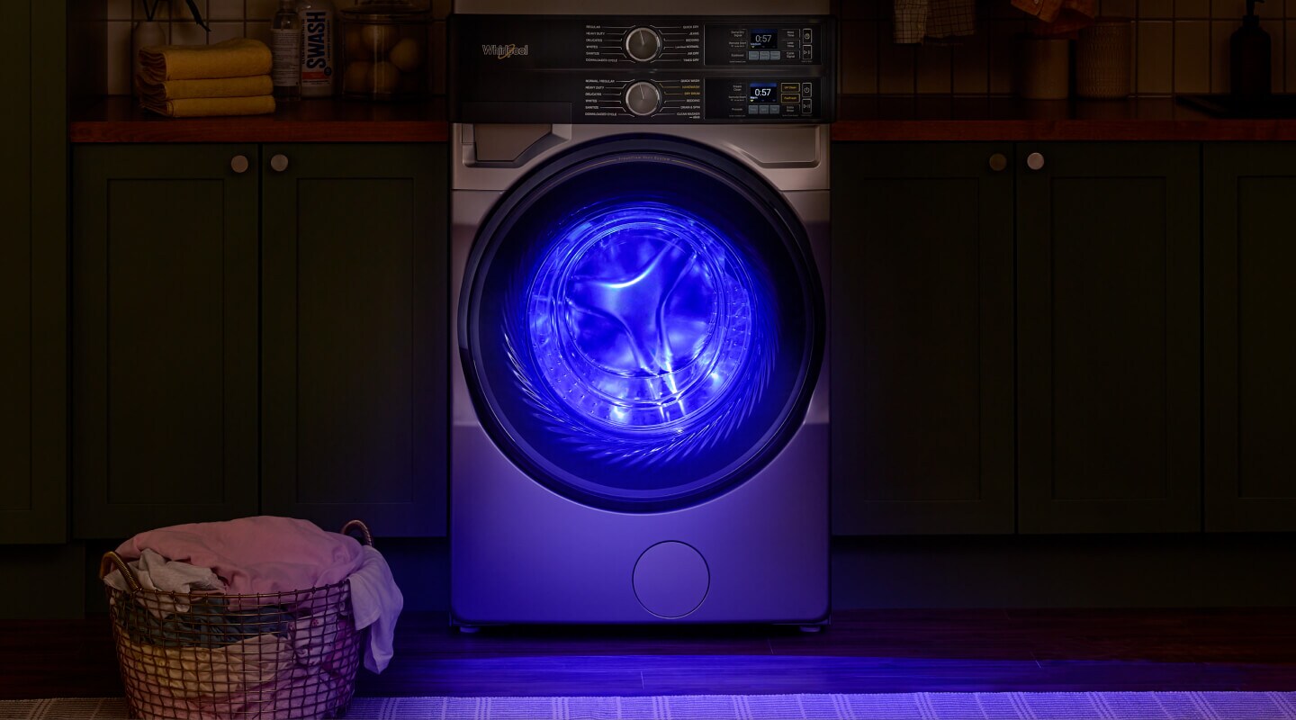 Blue UV light shining from inside a front load washer