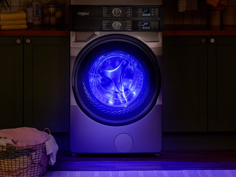 Blue UV light shining from inside a front load washer