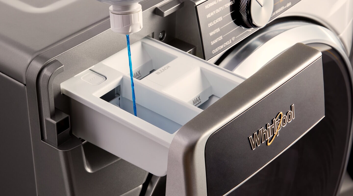 Person filling detergent compartment with laundry detergent