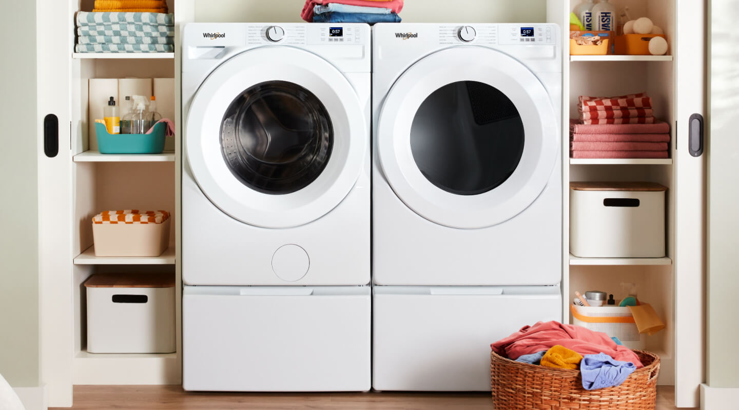 A Whirlpool® front load Washer and Dryer pair in a laundry area