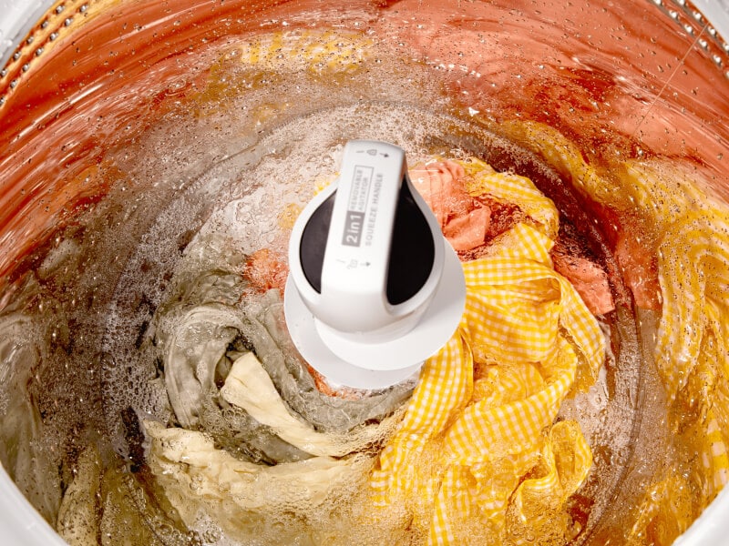 A close up of clothes in a Whirlpool® Top Load Washer with 2 in 1 Removable Agitator during a wash cycle A close up of clothes in a Whirlpool® Top Load Washer with 2 in 1 Removable Agitator during a wash cycle