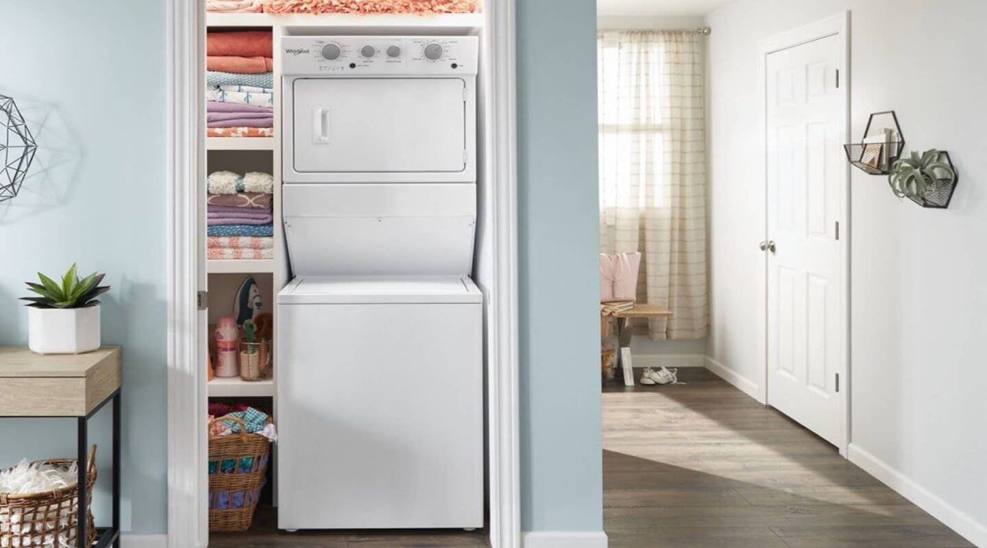A Whirlpool® Stacked Laundry Center tucked into a closet of a modern home