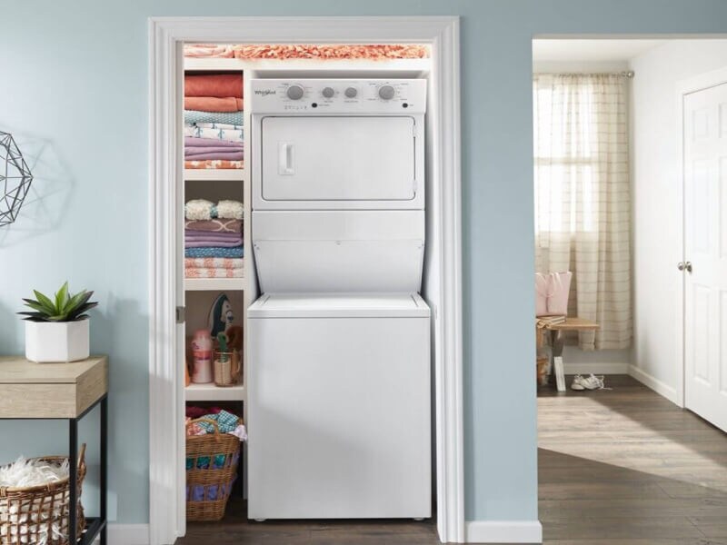 A Whirlpool® Stacked Laundry Center tucked into a closet of a modern home
