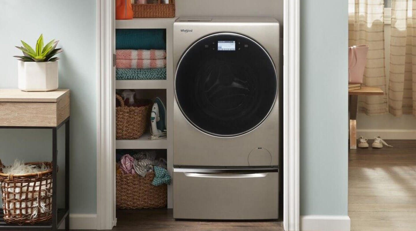A Whirlpool® Smart All-In-One Washer & Dryer tucked into a closet of a modern home