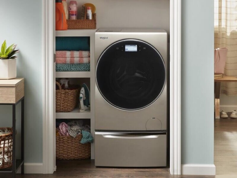 A Whirlpool® Smart All-In-One Washer & Dryer tucked into a closet of a modern home