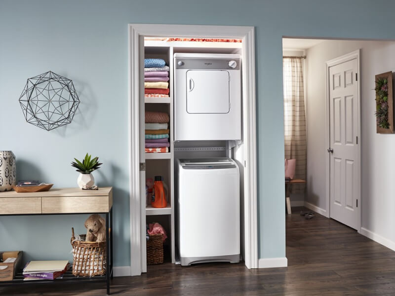 White stacked washer and dryer in a closet